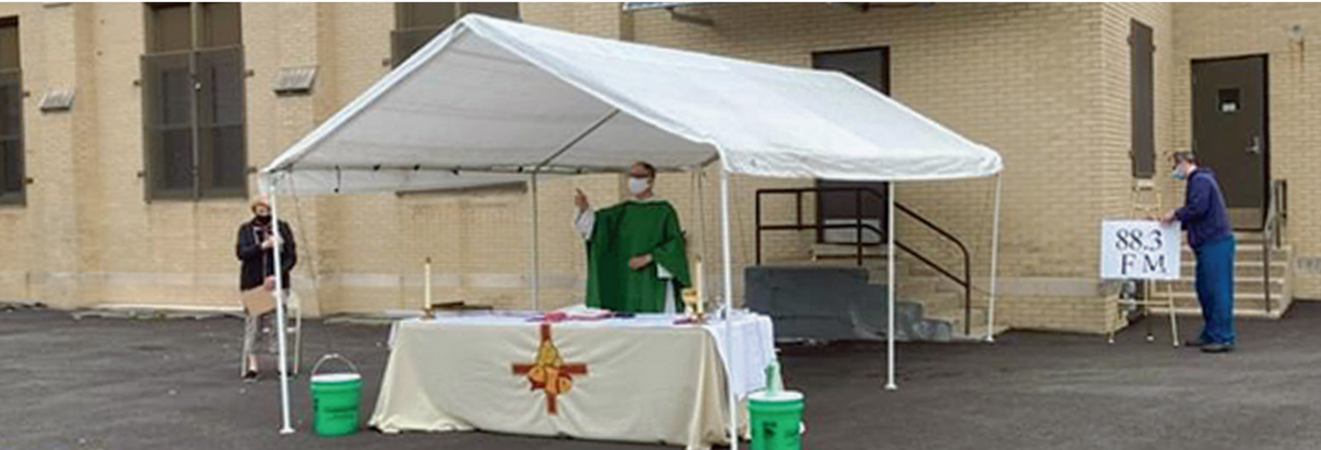 Fr. Steve Kuhlmann, O.P., celebrates drive-in Mass at St. Vincent Ferrer Parish in River Forest, Illinois