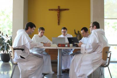Friars studying together at a table
