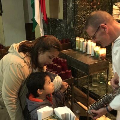 Fr. Mike shows relic to mother and child