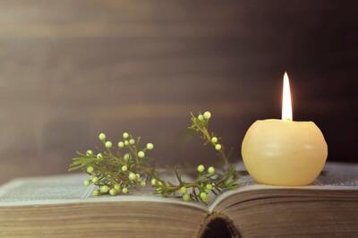 Candle on an open bible