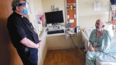 Fr. Pat Norris, OP, chaplain at SSM Health St. Mary’s Hospital in Madison, visits with patient Tom Donahue of Madison. (Photo courtesy of SSM Health St. Mary's Hospital)