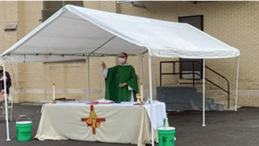 Fr. Steve Kuhlmann, O.P., celebrates drive-in Mass at St. Vincent Ferrer Parish in River Forest, Illinois